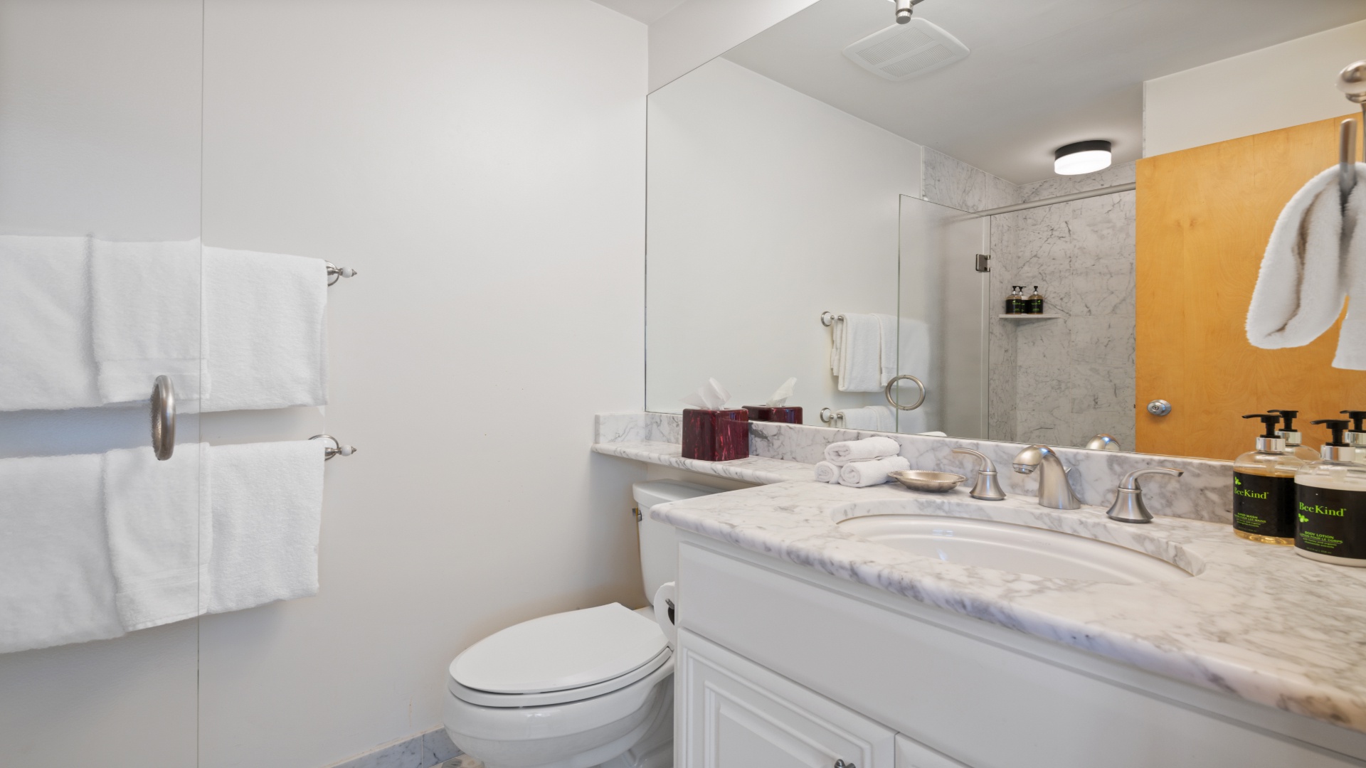 Refresh after a day of exploring in your private marble bathroom, complete with plush towels and premium amenities. The walk-in shower and thoughtful design make unwinding effortless.