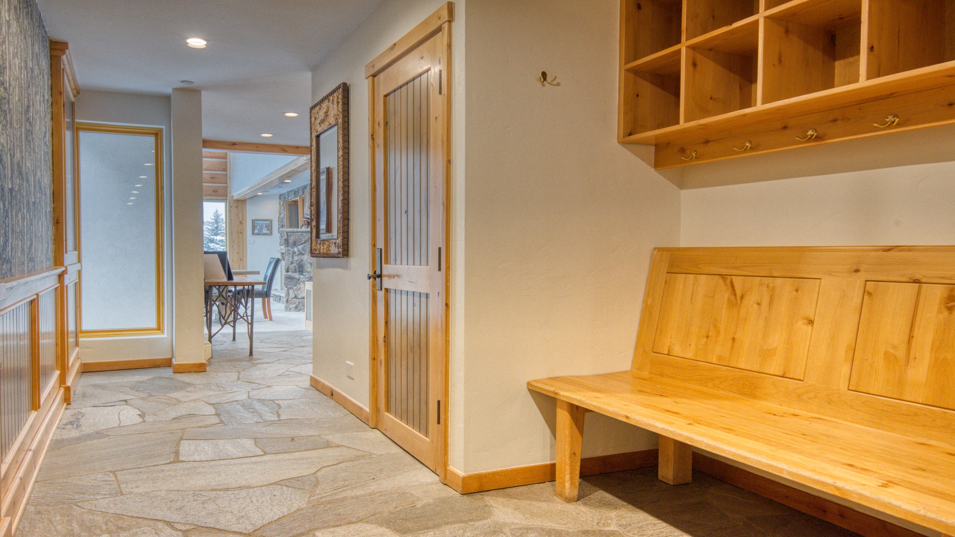 A welcoming entryway featuring handcrafted wooden storage and benches, inviting you to settle in after exploring nearby mountain trails and slopes.