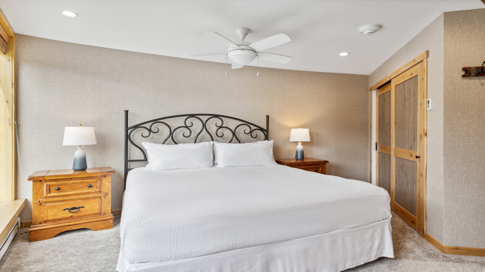 Sink into your plush bed with crisp white linens, feel the gentle ceiling fan breeze, and let the soft glow from your bedside lamps ease you into pure relaxation.