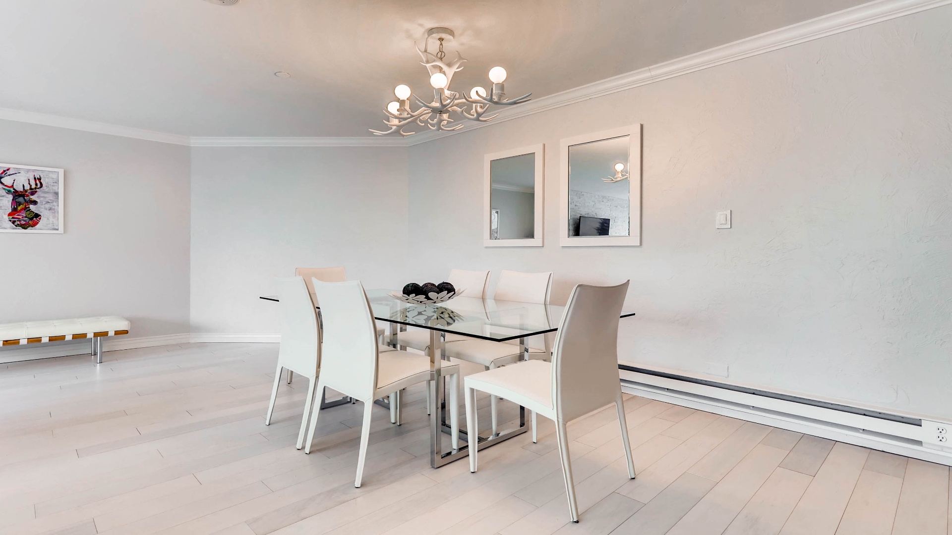 Gather around this sleek glass dining table in a bright, open space perfect for sharing meals and making memories during your stay.