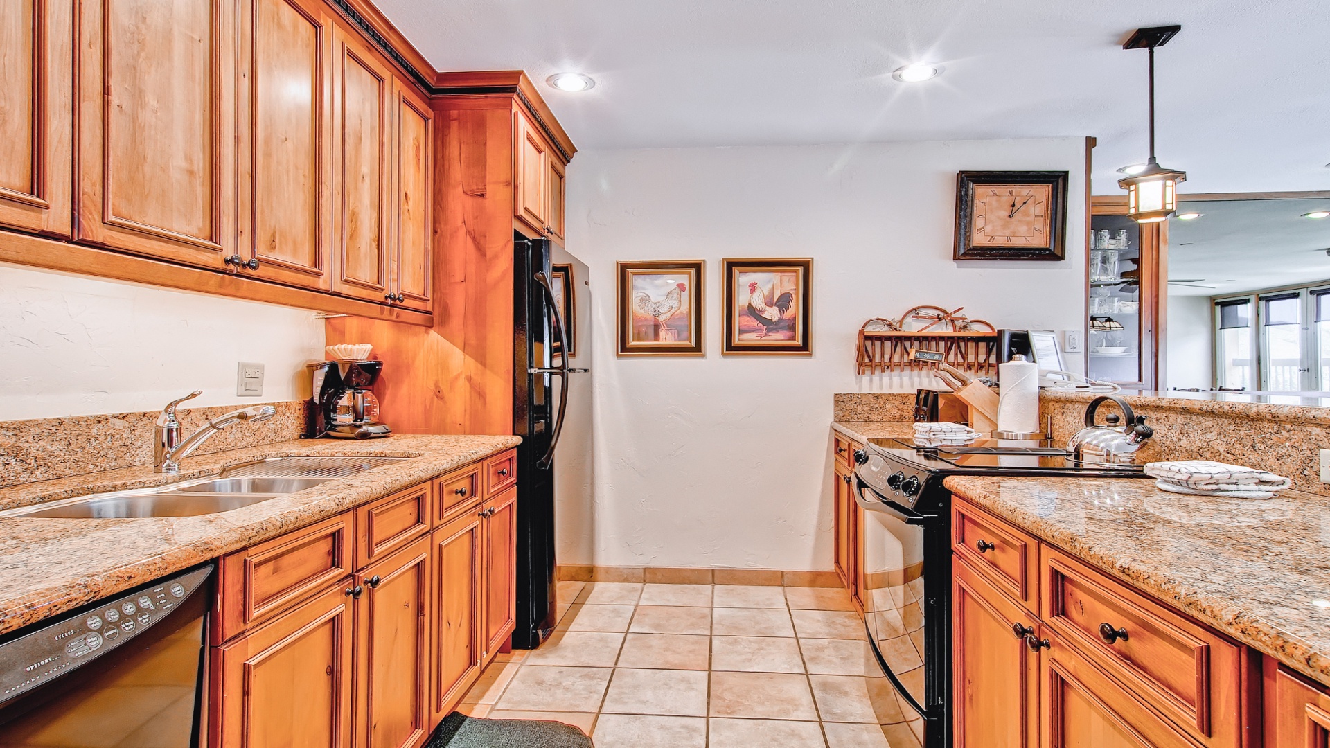 Your fully equipped kitchen features granite countertops, warm wood cabinetry, and modern appliances—everything you need to prepare delicious meals during your stay.