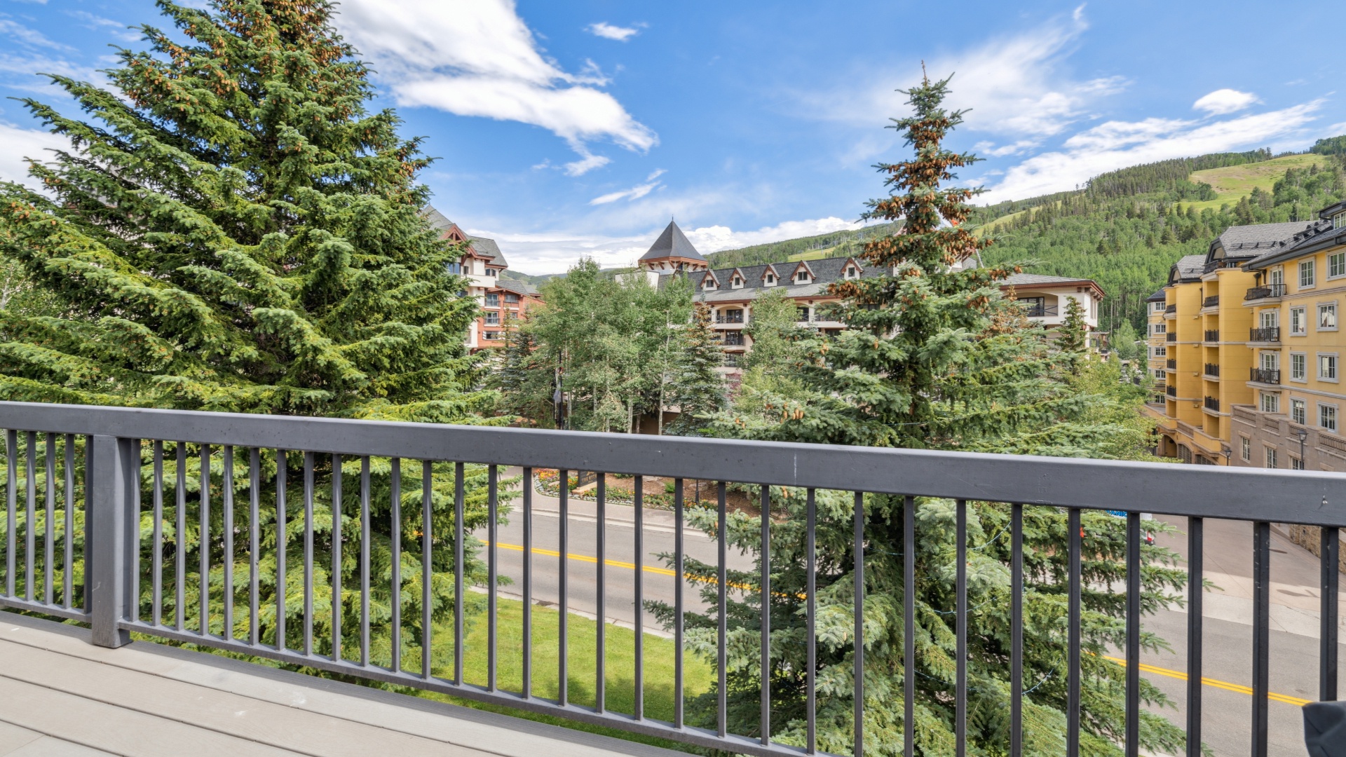 A mountain village resort area surrounded by evergreen forests and alpine hillsides, visible from the property's location.