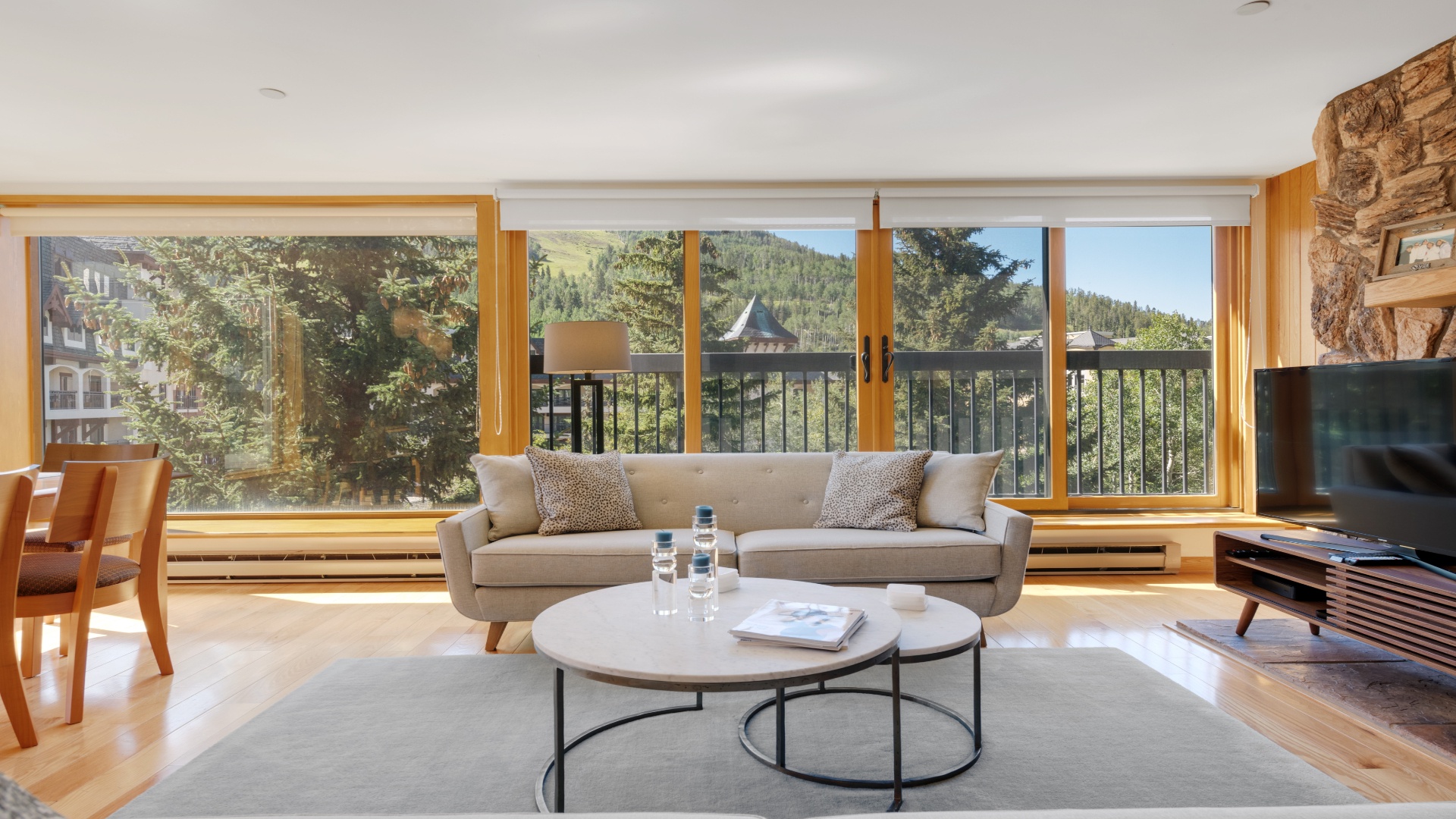 Sink into plush comfort and soak up the stunning alpine views from your bright, sunlit living room. Natural wood accents and mountain vistas create a serene escape for your getaway.