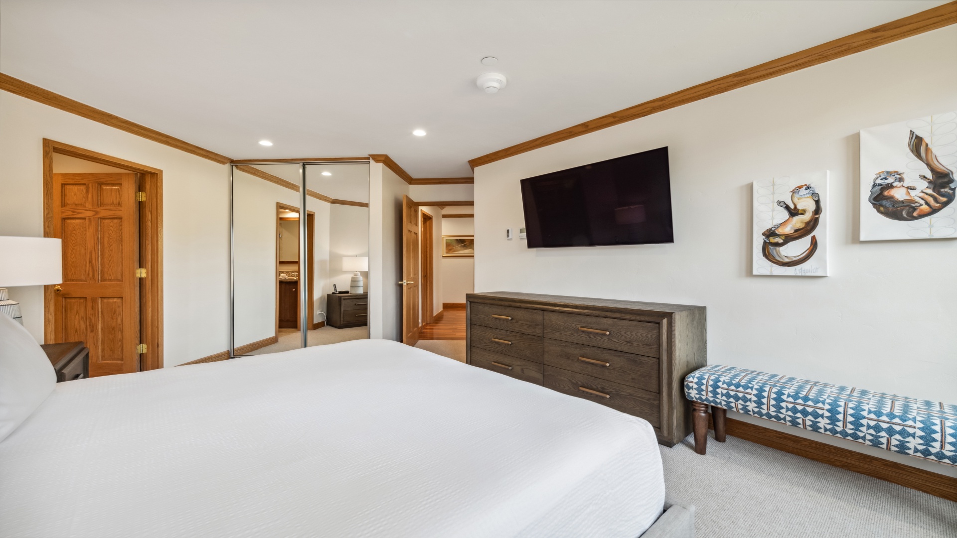 Unwind in your spacious bedroom with a plush bed, smart TV for streaming, and mirrored wardrobe—your peaceful retreat after a day of exploring.