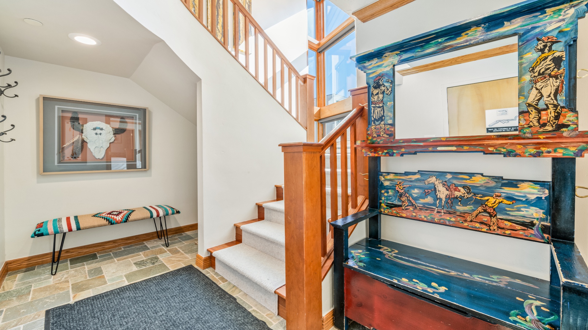 Colorful artistic stairway leads to your private loft space, flanked by vibrant handcrafted details and warm wood tones that create a welcoming, creative atmosphere.