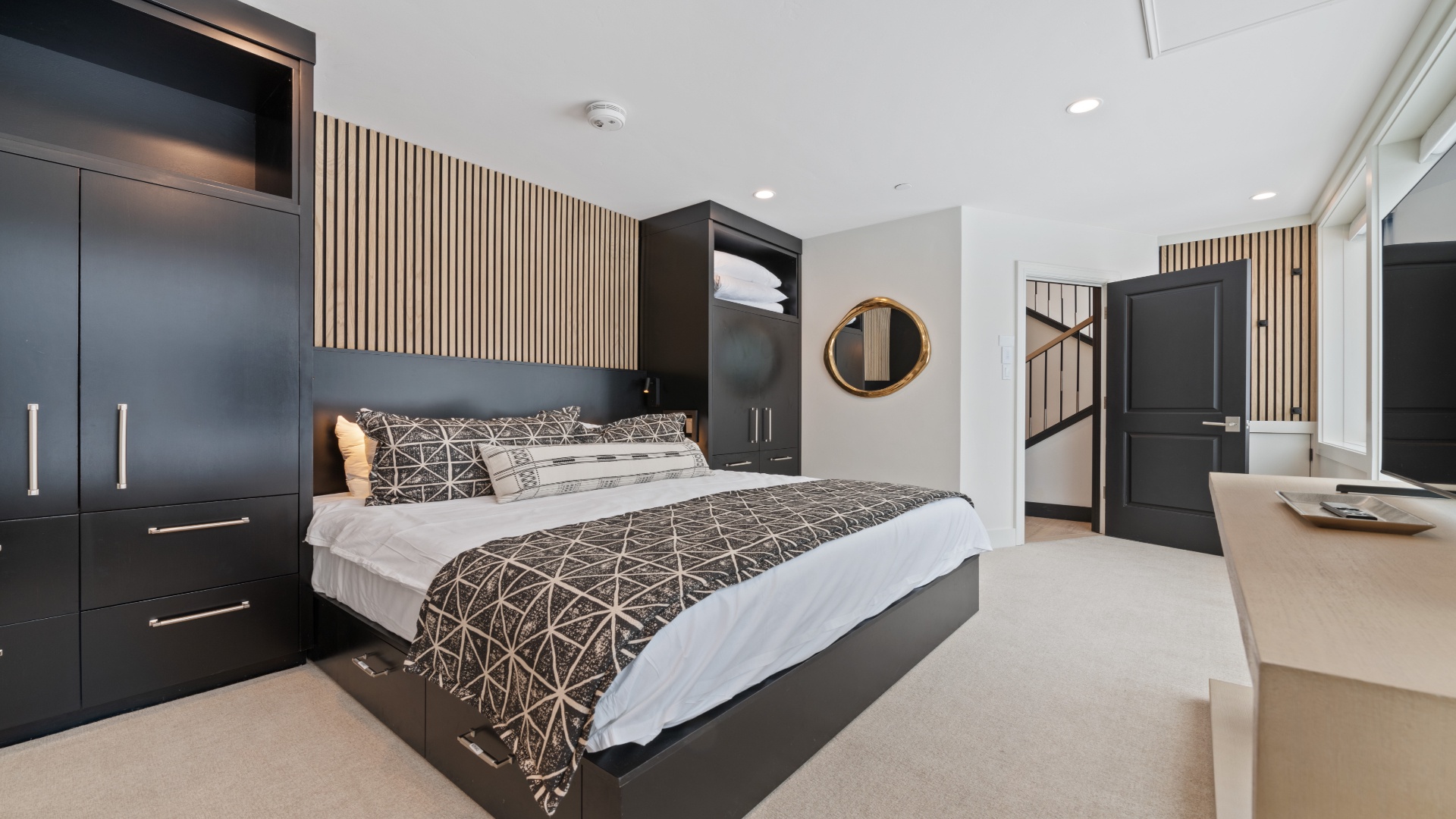 Settle into your beautifully designed bedroom with sleek built-in storage, warm wood accents, and a plush bed dressed in modern linens—your peaceful retreat awaits.
