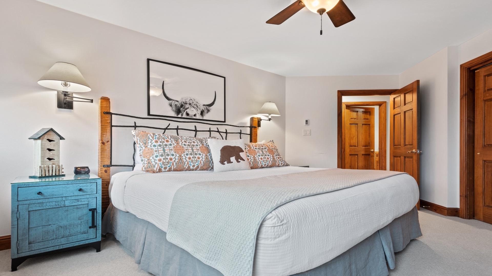 Picture yourself unwinding on this plush bed, surrounded by rustic charm and cozy lighting. The soft linens and whimsical accents create a welcoming retreat where you'll drift off peacefully.