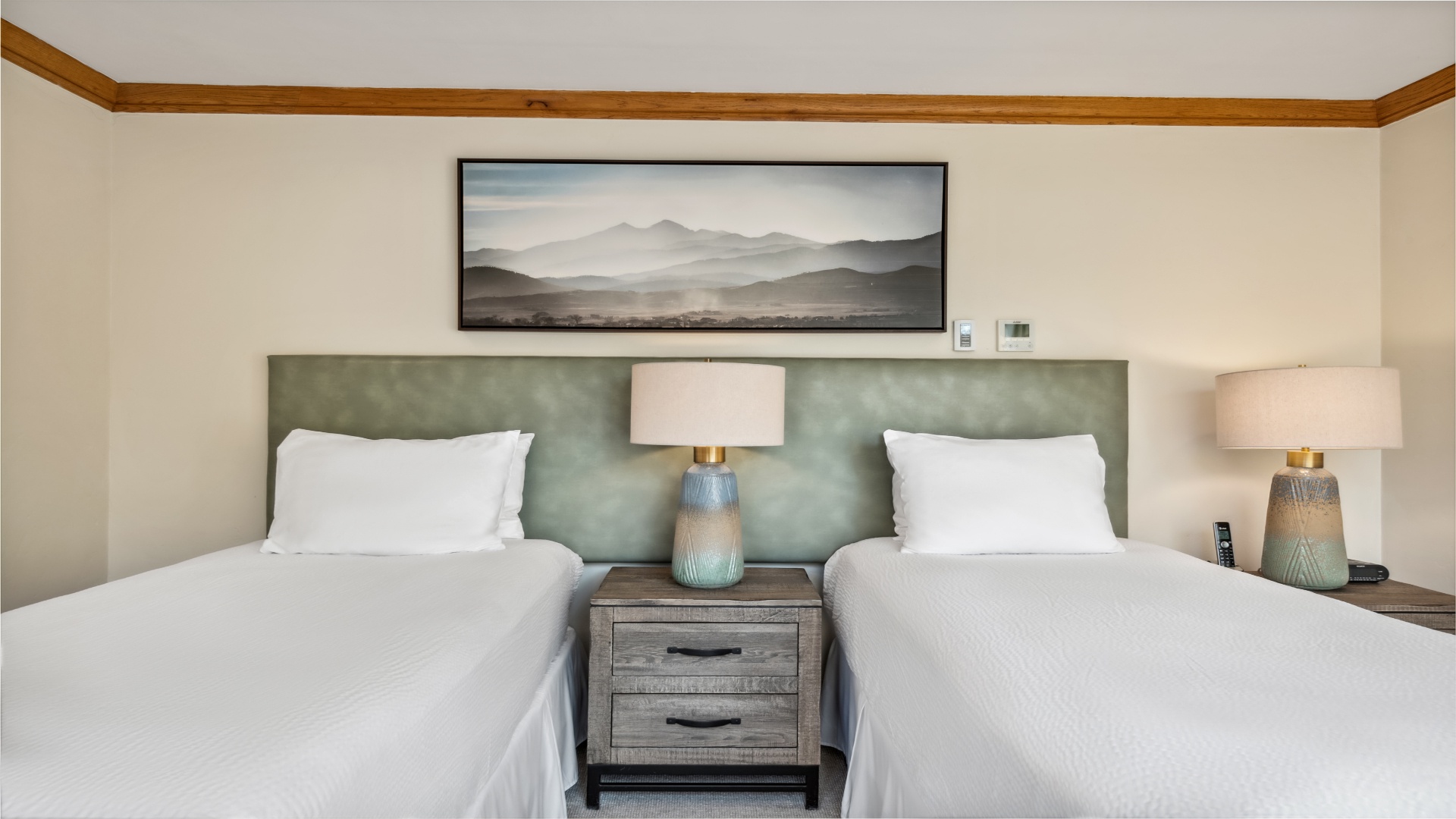 Sink into plush linens and wake to mountain art that brings serenity right to your bedside. These twin beds promise restful nights and peaceful mornings.