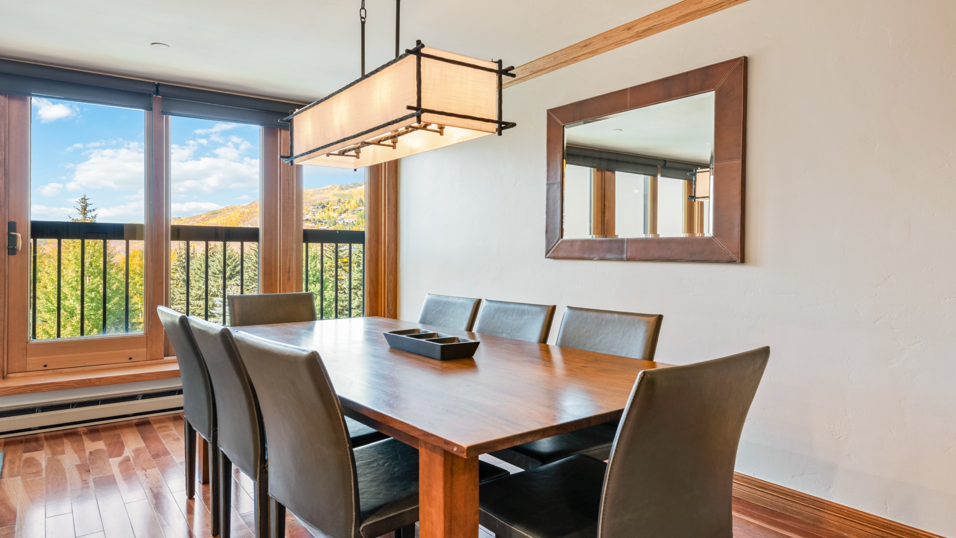 Gather around this spacious dining table with mountain views framing every meal, where your group can share stories and plan adventures in comfort.