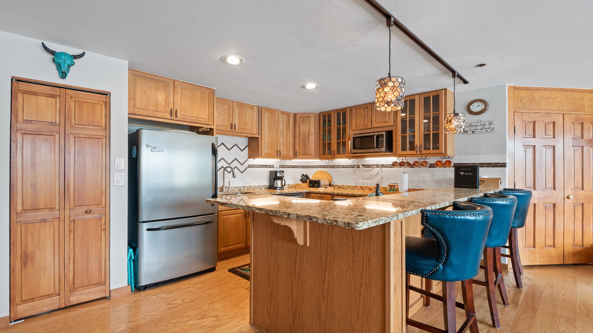 Cook your favorite meals in this fully equipped kitchen with granite countertops, modern appliances, and a welcoming island where you can gather with loved ones over morning coffee or evening snacks.