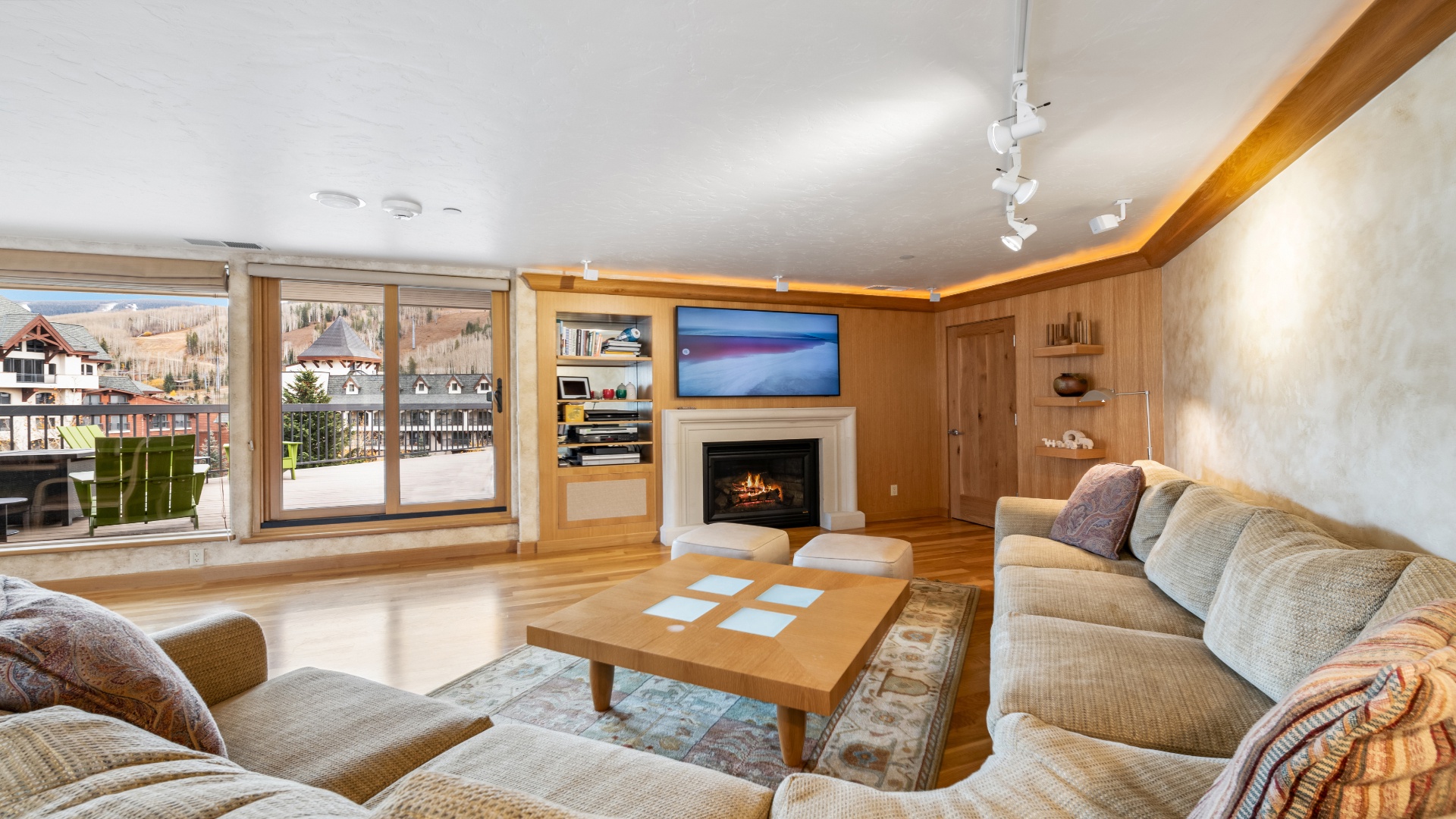 Curl up in this sun-drenched living room where mountain views meet cozy elegance. Plush seating surrounds a warm fireplace, inviting you to unwind after a day of adventure.