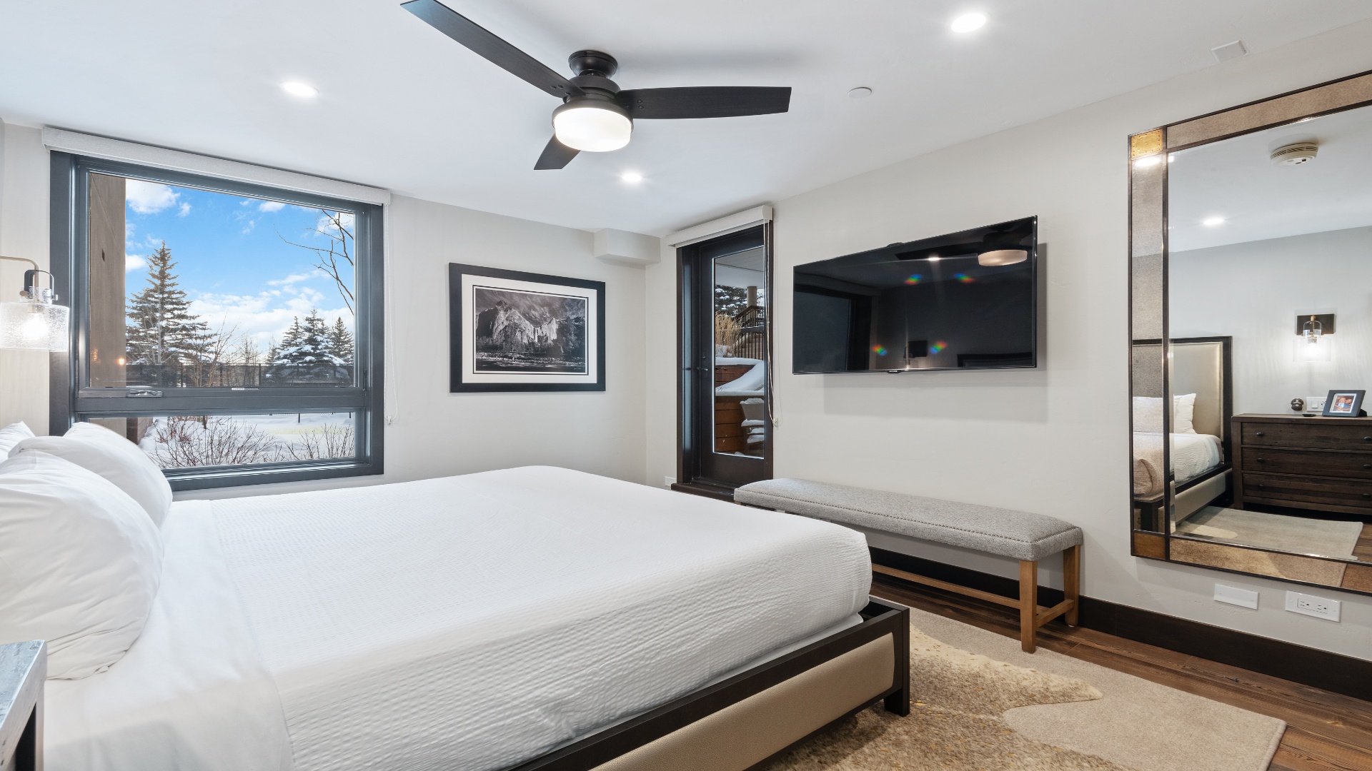 Step into your serene retreat where crisp linens and modern design await. Large windows frame peaceful neighborhood views, while a ceiling fan keeps you comfortable year-round in this stylish, thoughtfully appointed bedroom.