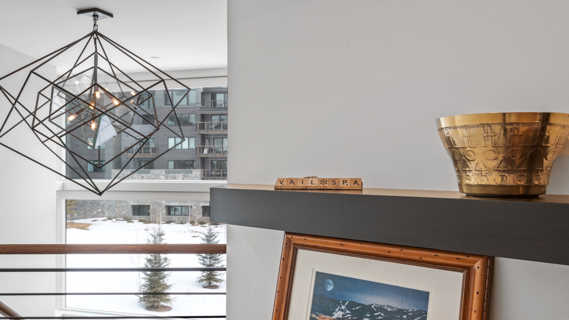 Stylish geometric light fixture adds modern elegance to this bright, airy space. You'll enjoy city views and mountain art that create a sophisticated, welcoming atmosphere.