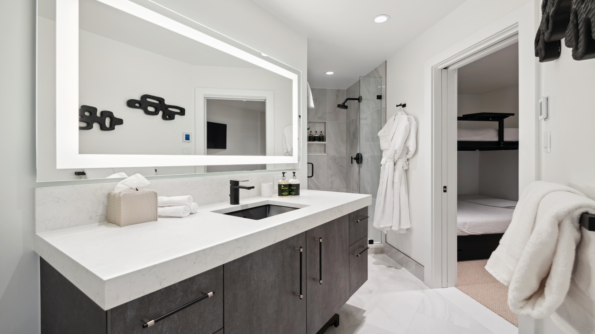 Your elegant ensuite awaits with sleek modern finishes, a spacious walk-in shower, and plush robes ready for ultimate relaxation after a day of exploring.