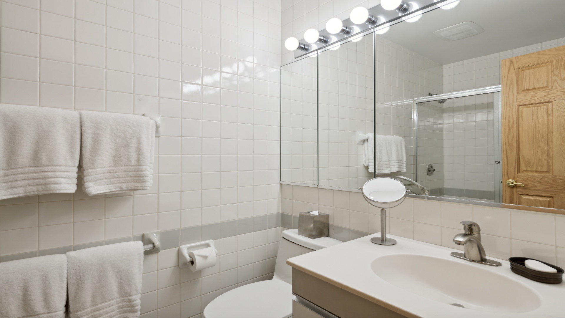 Step into your private, sparkling-clean bathroom with fresh towels waiting, a well-lit vanity for your morning routine, and a relaxing shower ready to refresh you after your adventures.