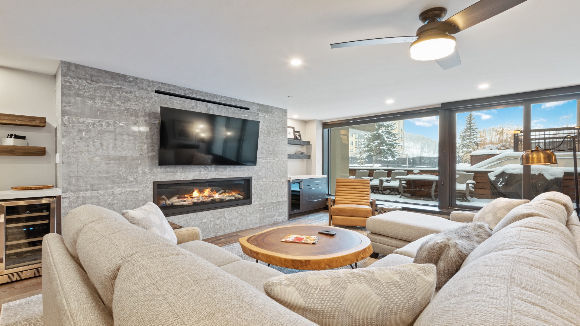 Sink into plush seating by your modern fireplace, with mountain views and snowy slopes visible through floor-to-ceiling windows—your perfect alpine retreat awaits.