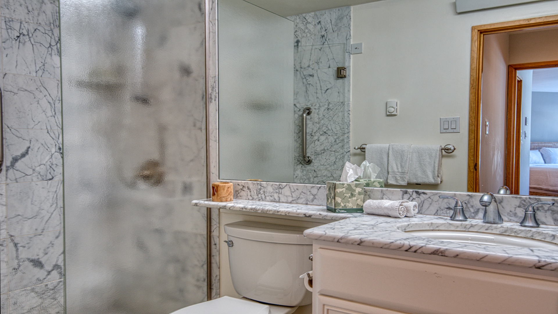Elegant marble finishes and plush towels await in your private en-suite bathroom, designed for comfort and convenience during your stay.