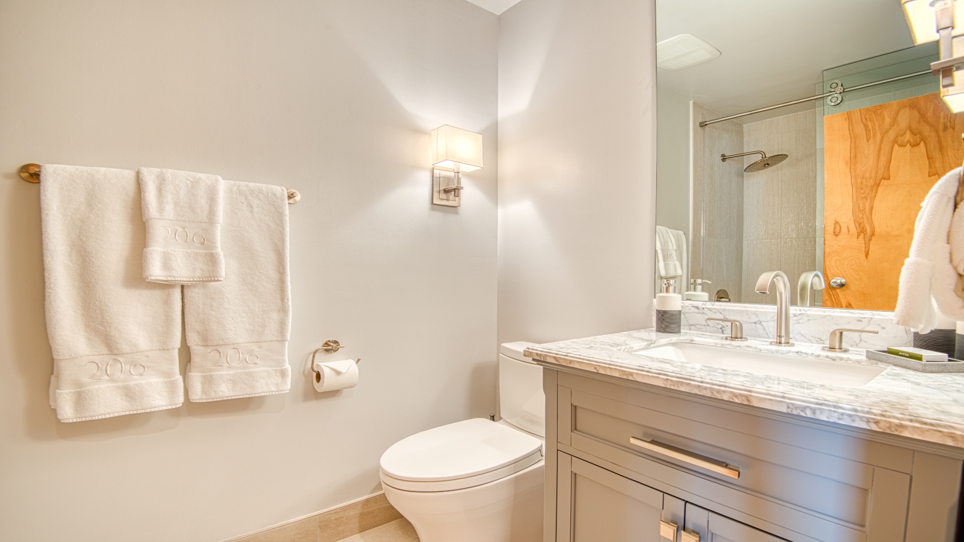 Step into your spa-like retreat with plush towels, elegant marble countertops, and a rainfall shower—your perfect place to refresh and unwind.