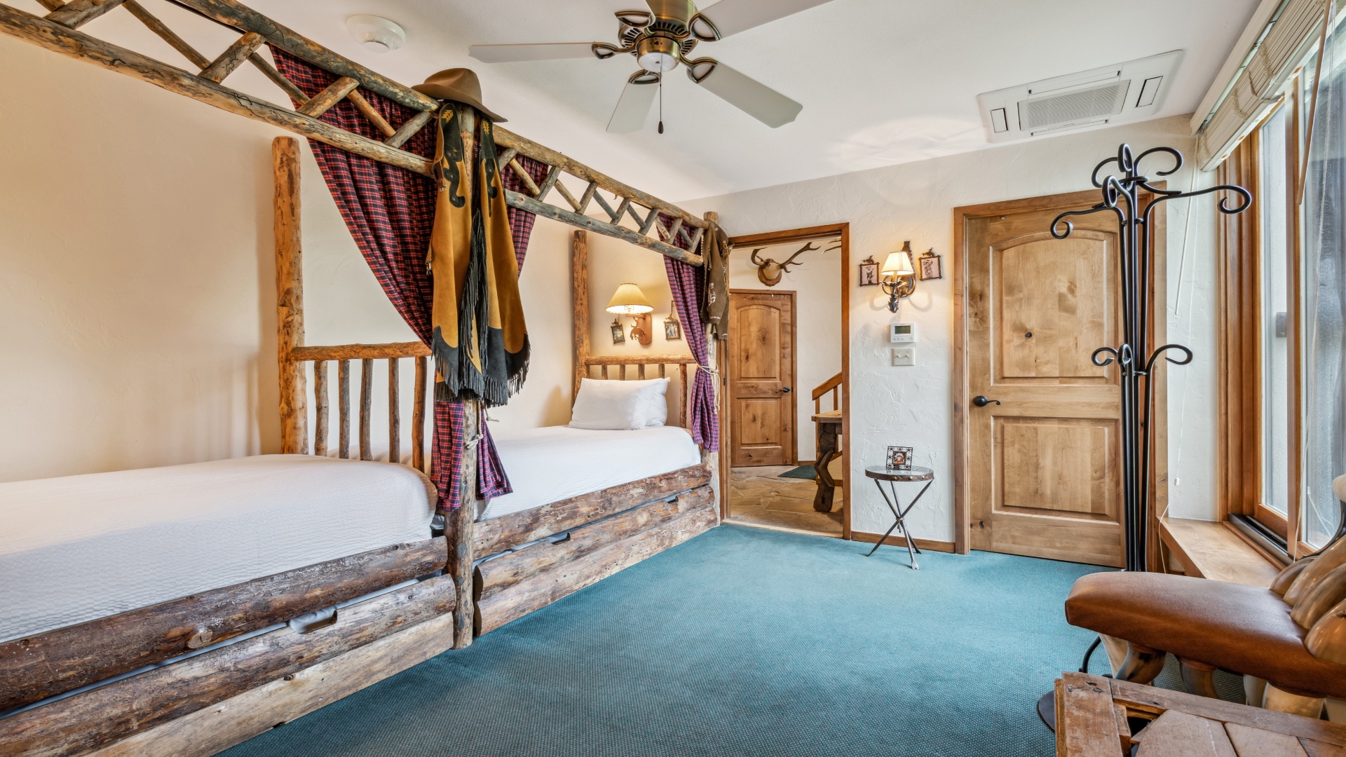 Your cozy, mountain-inspired bedroom features rustic log furniture, plush bedding, and charming Western details that create a warm and inviting retreat after a day of adventure.