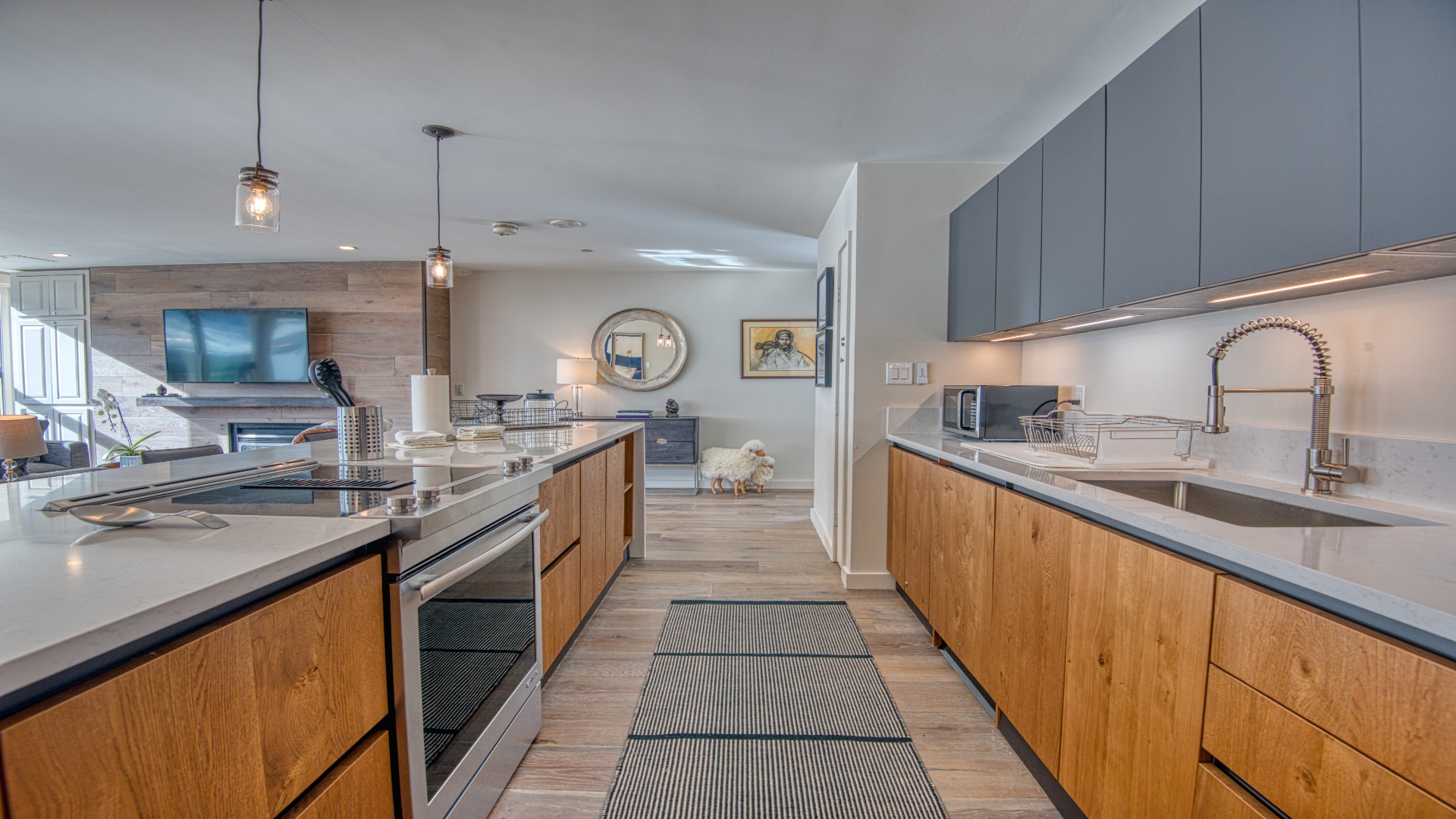 Step into your beautifully designed kitchen where warm wood tones meet sleek modern countertops. Gather around the spacious island or whip up meals with high-end appliances while enjoying the open flow into your living area.
