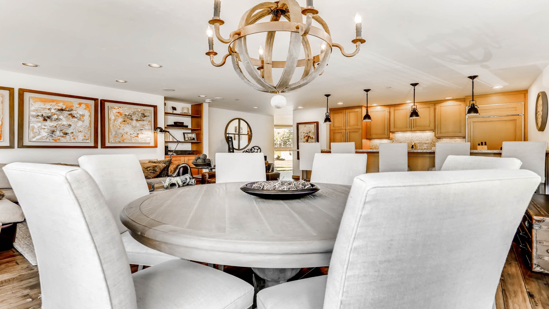 Gather around your elegant dining table where a stunning chandelier sets the mood for memorable meals with loved ones in this open-concept space.