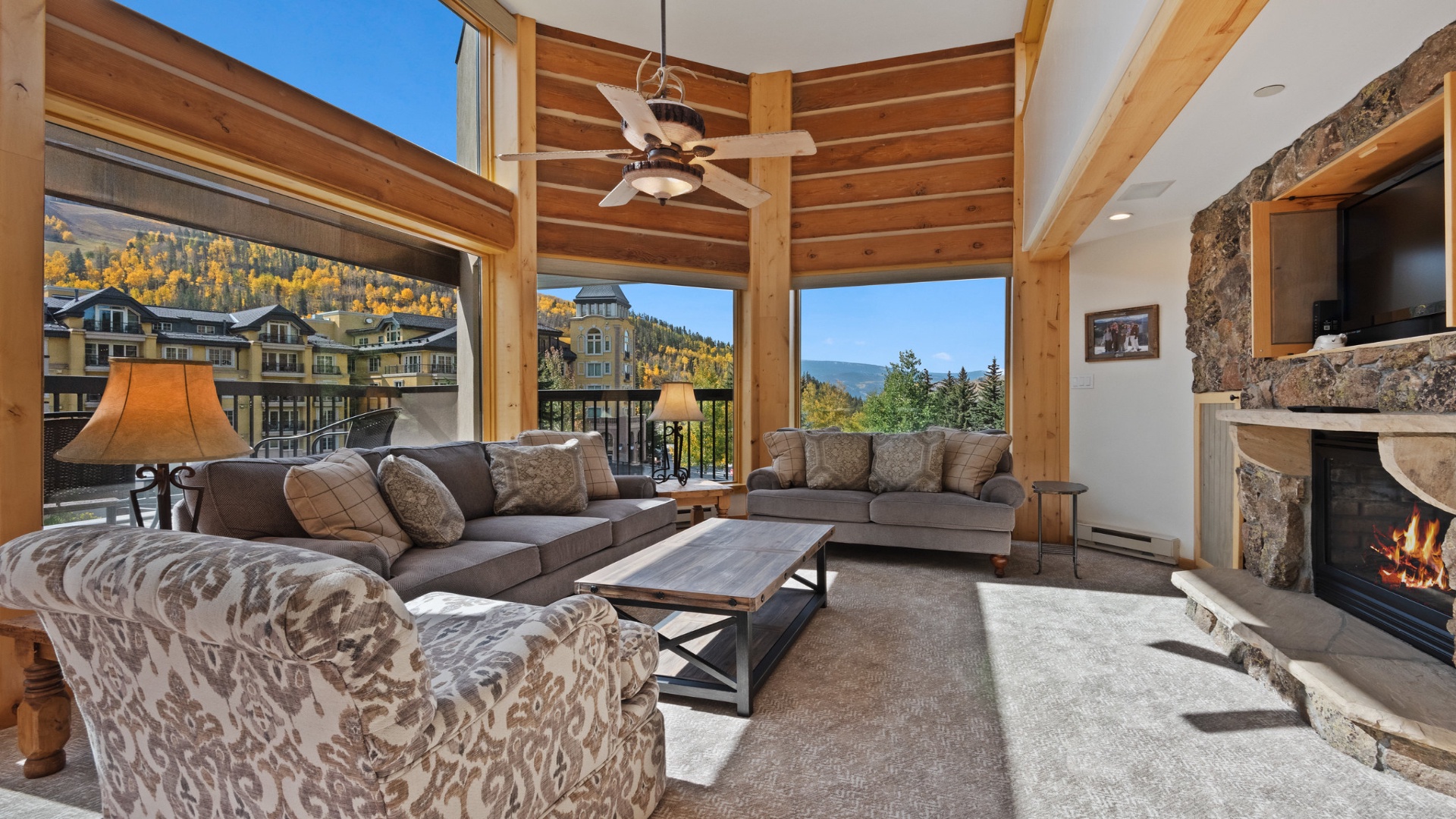 Sink into plush seating and take in stunning mountain views through floor-to-ceiling windows. Your cozy evenings by the stone fireplace start here.