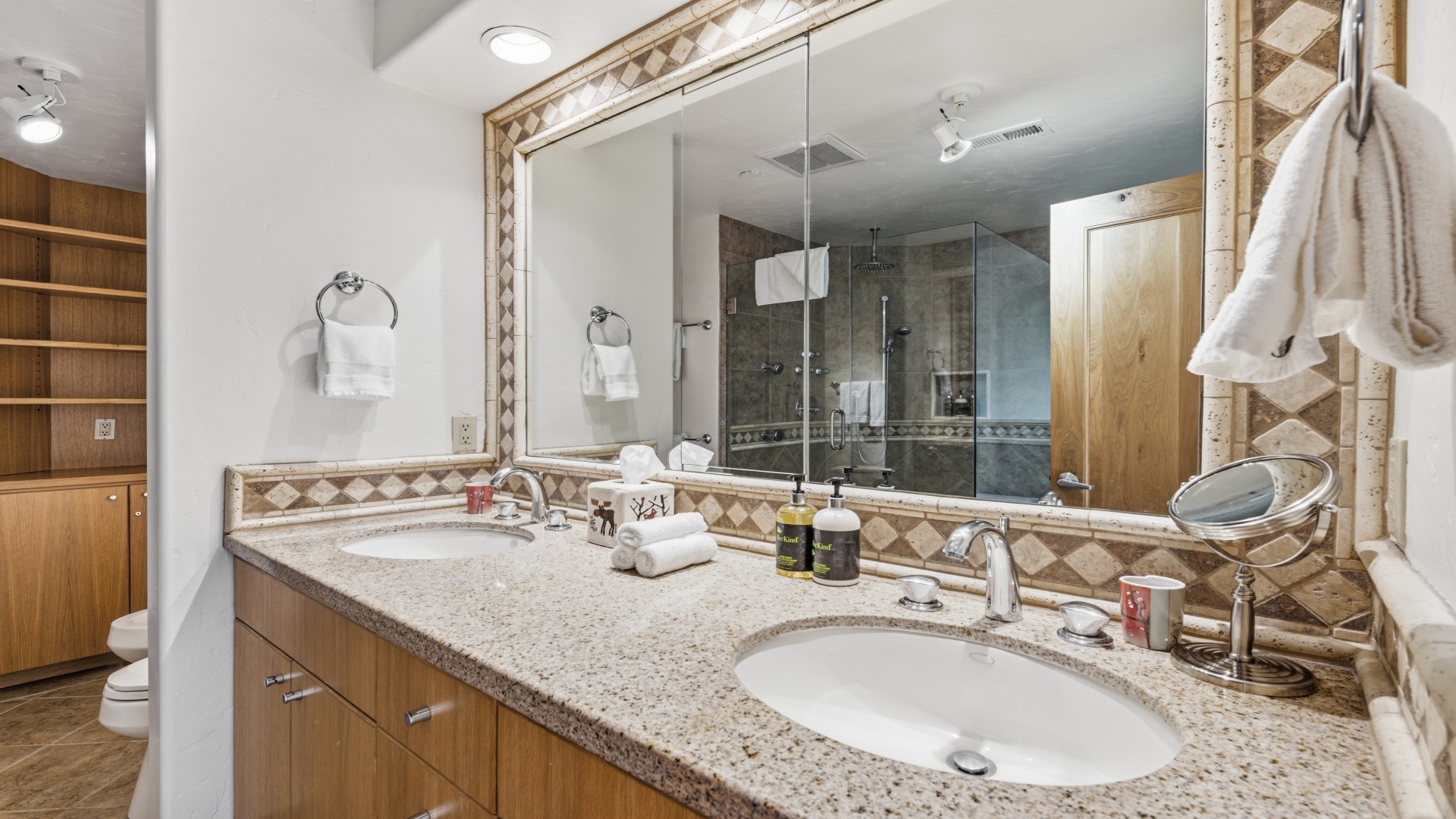 Your spacious bathroom features dual sinks, elegant granite countertops, and a luxurious walk-in shower, creating the perfect retreat after a day of adventure.