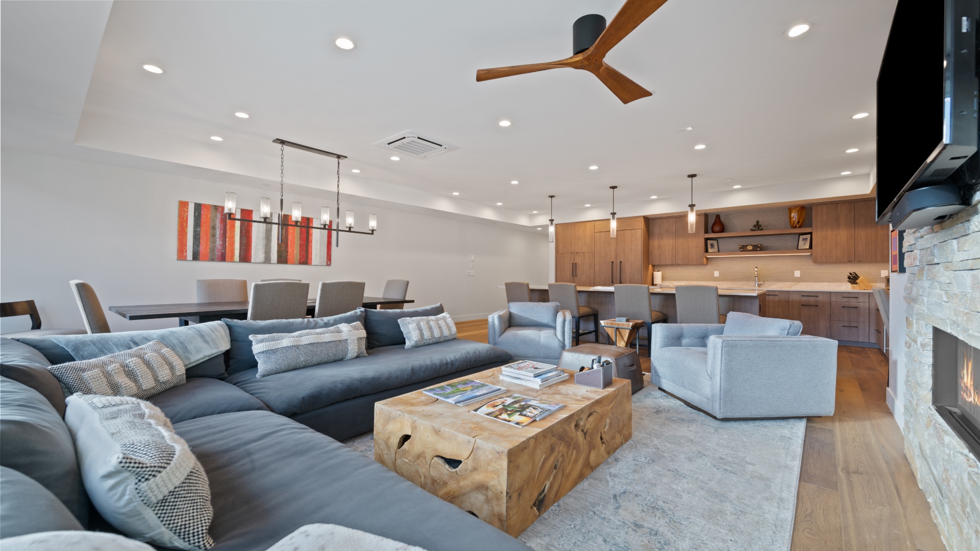 Step into your spacious open-concept retreat, where modern elegance meets mountain charm. Relax on plush seating, gather around the cozy fireplace, and enjoy a fully-equipped kitchen perfect for your getaway.