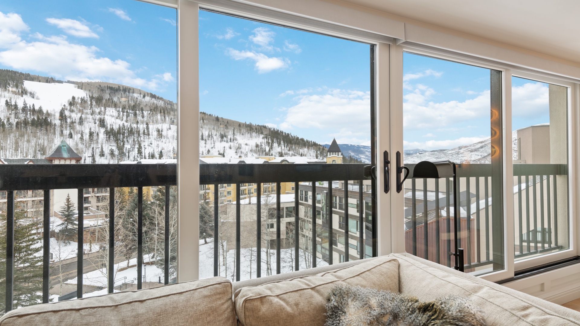 Soak in breathtaking mountain views from your cozy window seat, where snowy peaks and blue skies create the perfect alpine backdrop for your getaway.