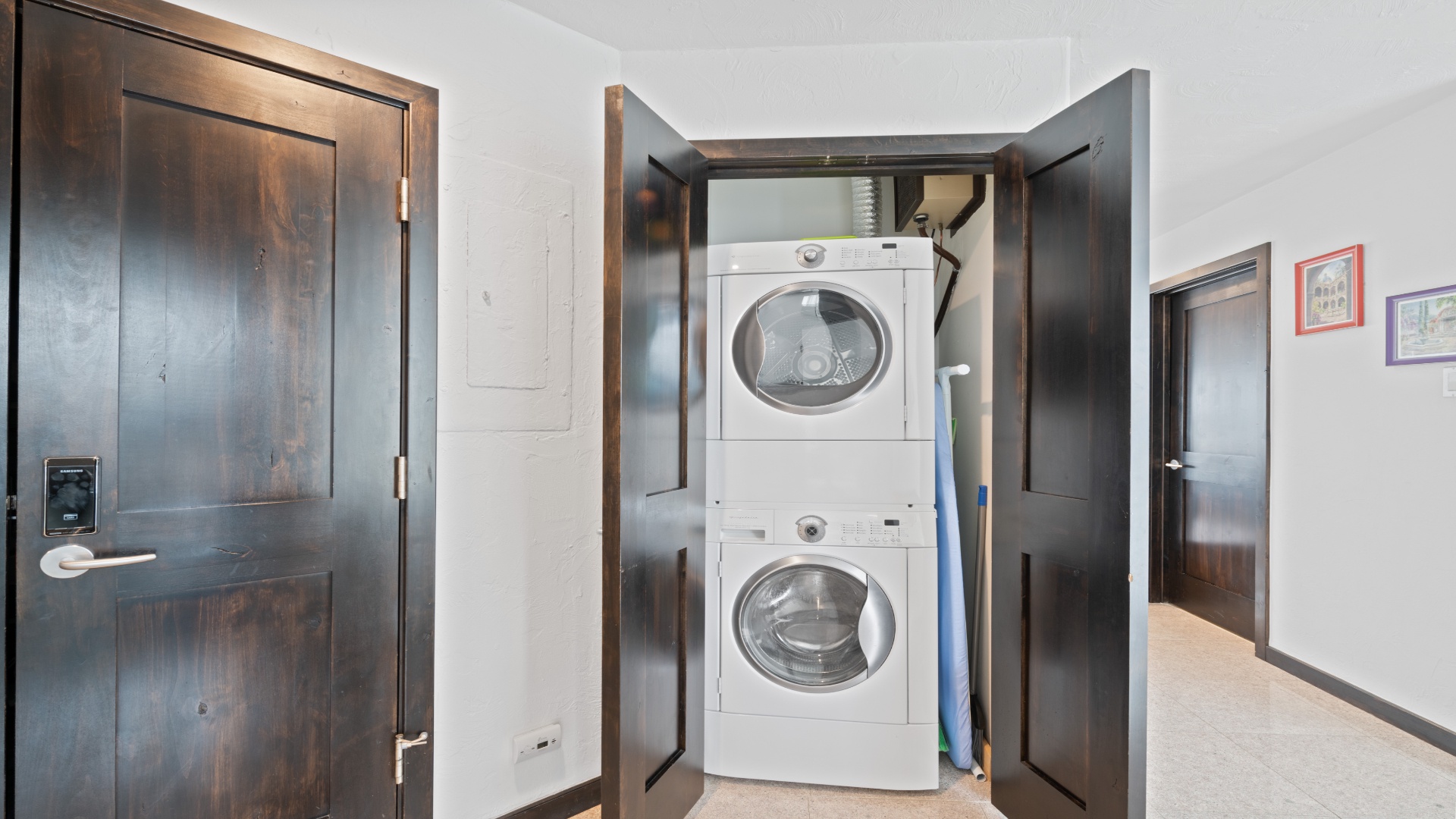 Your in-unit washer and dryer are tucked neatly into a stylish cabinet, making laundry effortless during your stay without ever leaving your space.