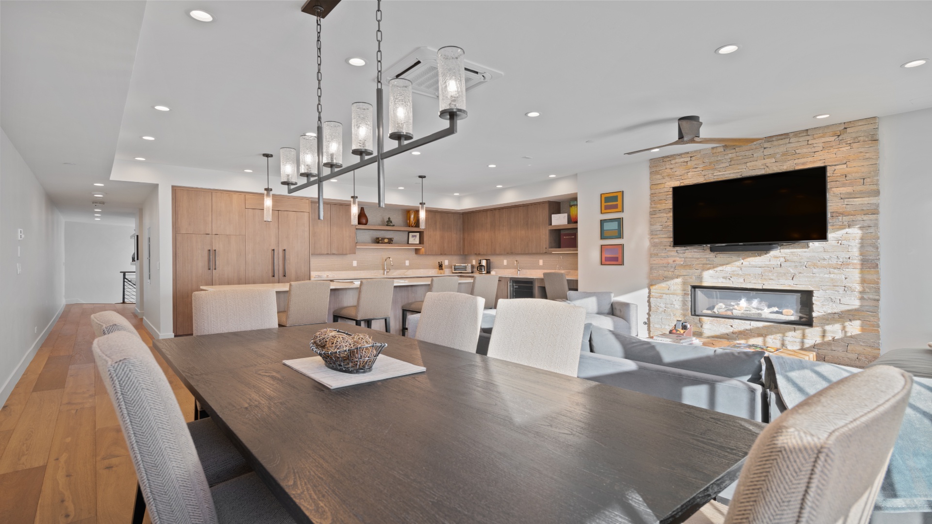 Gather around this spacious dining table where your group can share meals and stories. A modern fireplace and open kitchen complete your home-away-from-home.