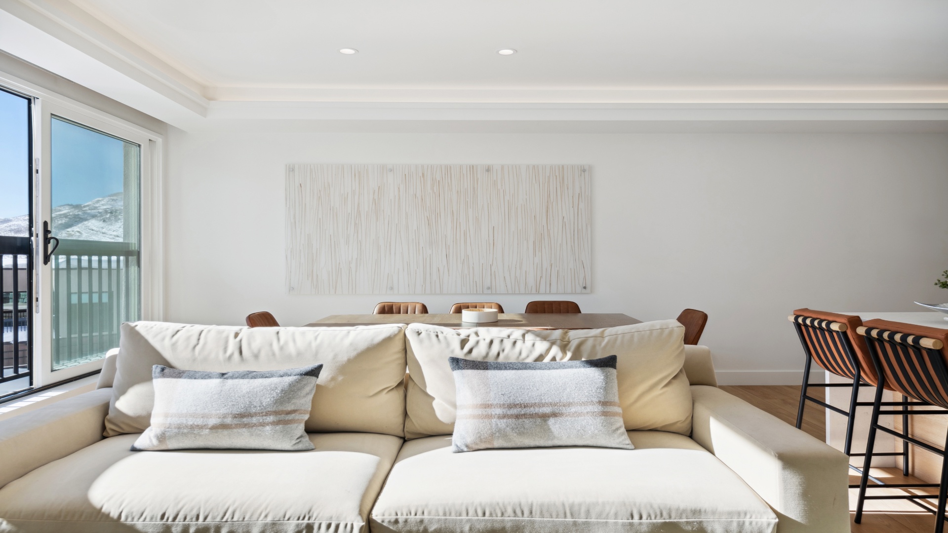 Sink into plush seating and savor coastal vistas just beyond your door, where modern elegance meets beachside tranquility in your open, airy retreat.