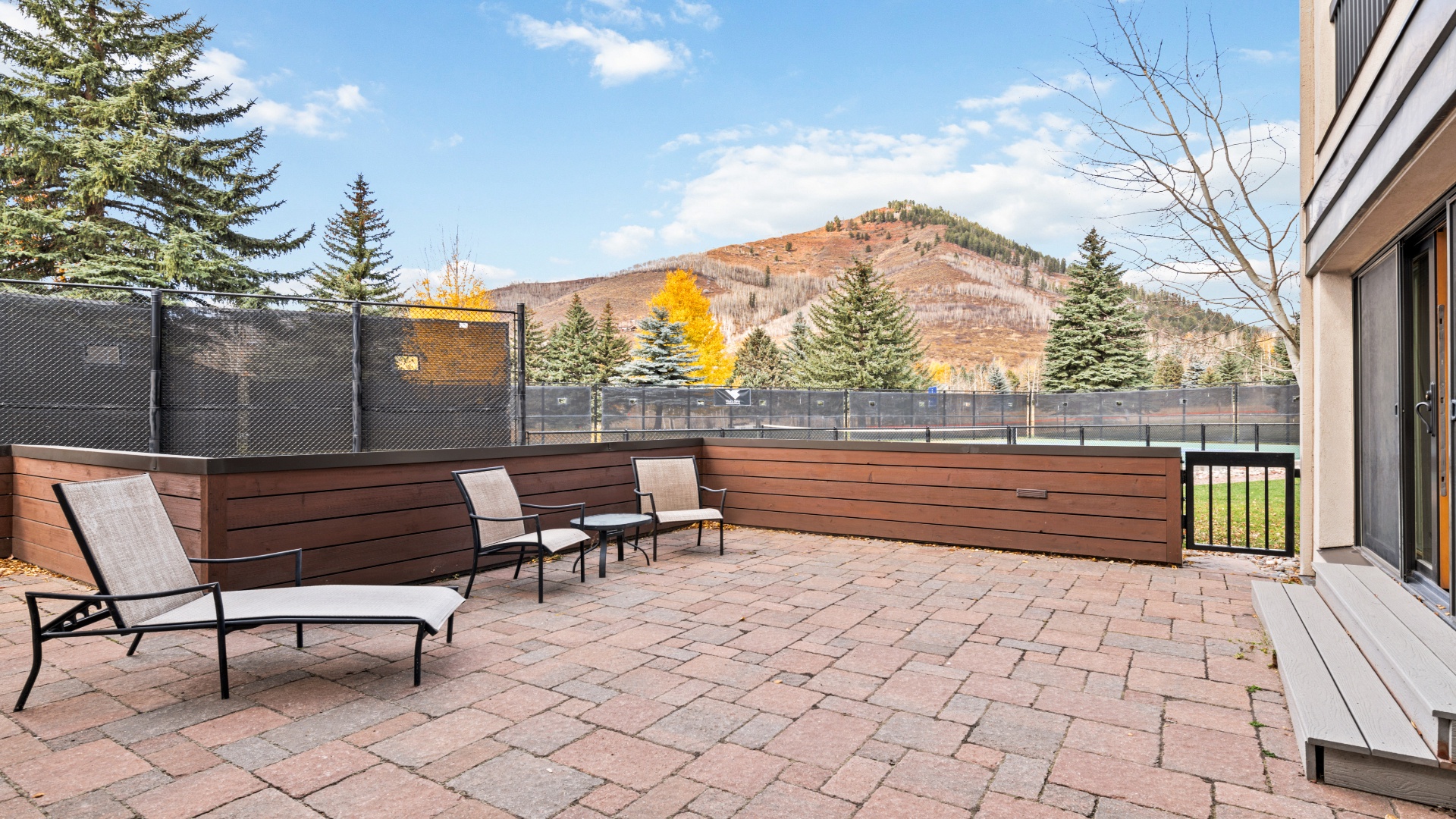 A spacious patio with mountain views and autumn foliage provides the perfect setting for morning coffee or evening relaxation under the open sky.