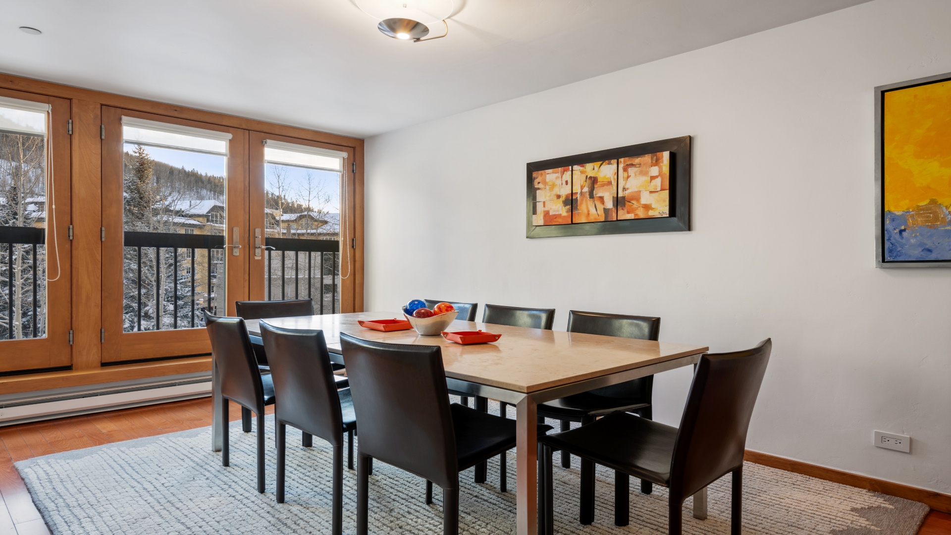 Gather around this spacious dining table with mountain views framing your meals—perfect for sharing stories over breakfast or planning your next adventure together.