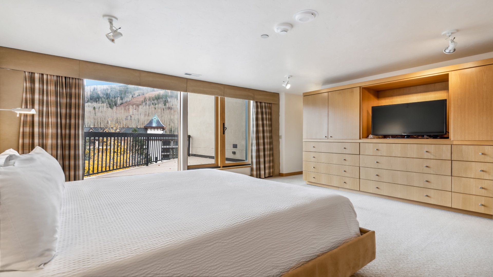 Wake up to stunning mountain views from your bed. This spacious bedroom opens to a private balcony where you can enjoy your morning coffee surrounded by nature's beauty.