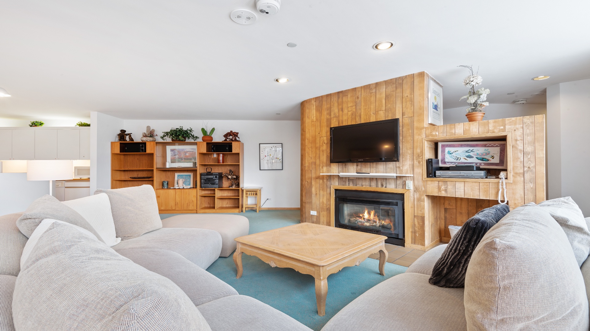 Sink into plush sofas around the fireplace, enjoy your favorite shows on the flat-screen TV, and unwind in this inviting, light-filled space designed for your ultimate relaxation.