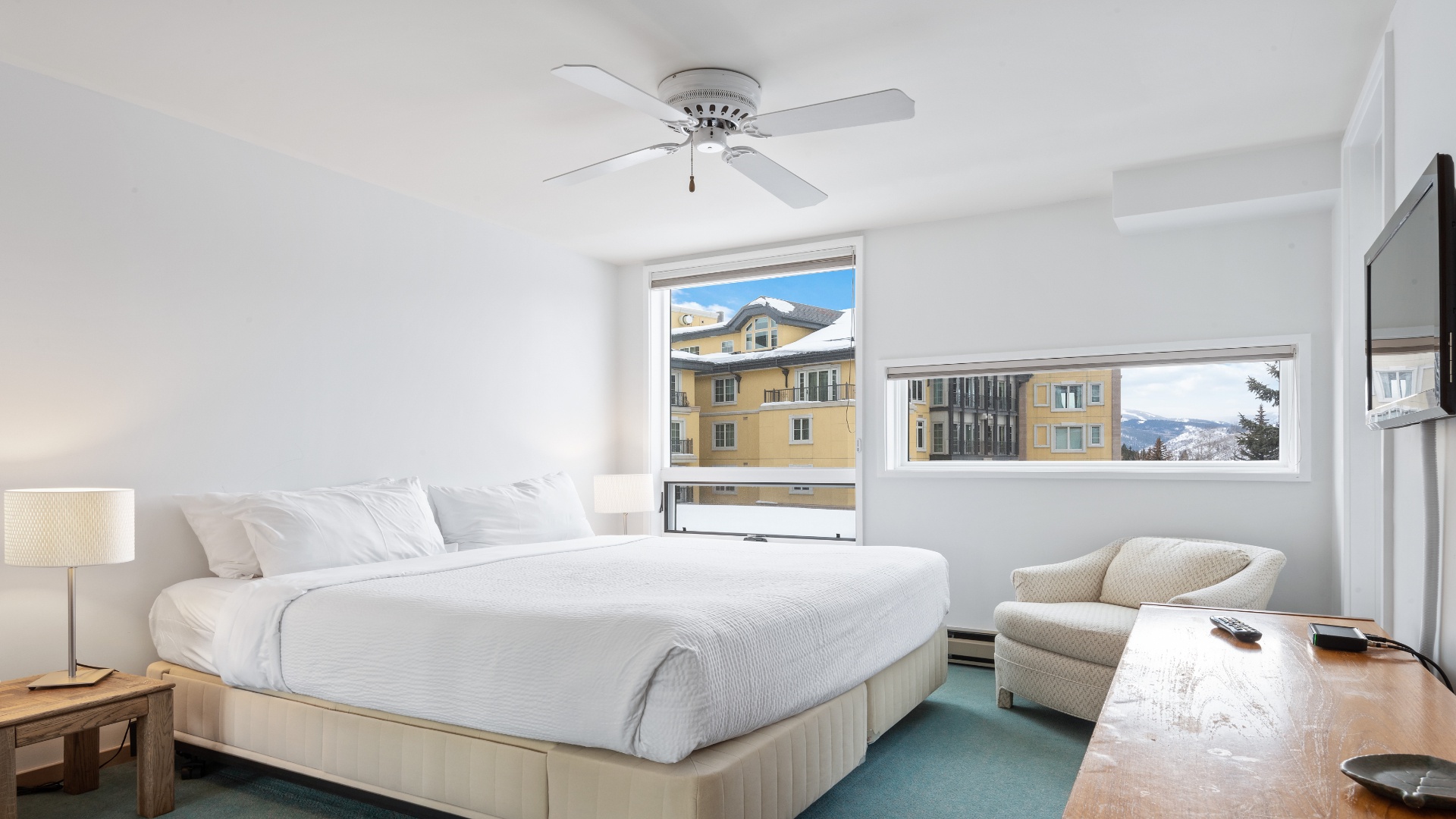Sink into crisp linens and let your mountain views frame your mornings. This serene bedroom pairs comfort with alpine charm, inviting you to relax.