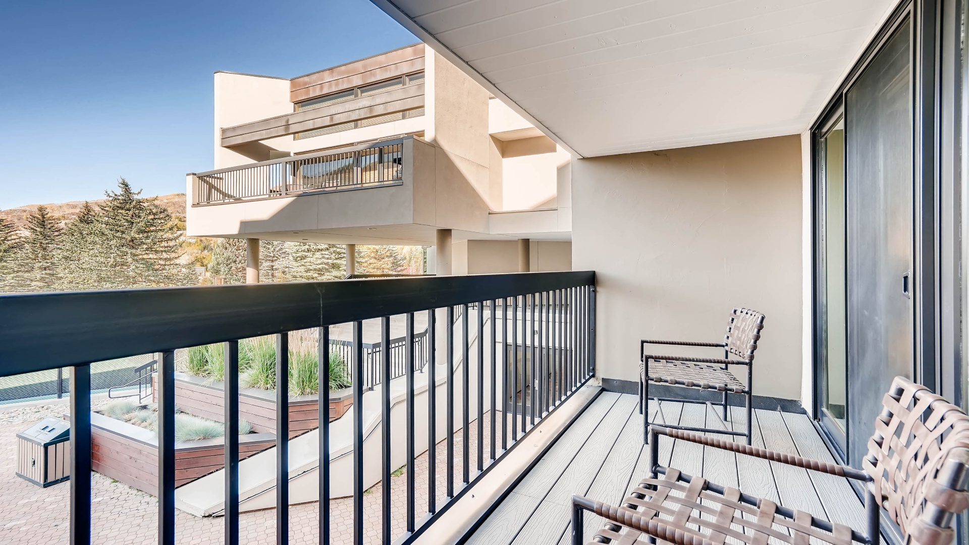 Step onto your private balcony and breathe in the mountain air. Comfortable seating invites you to relax, soak up the sunshine, and take in the peaceful surrounding landscape and modern architecture.