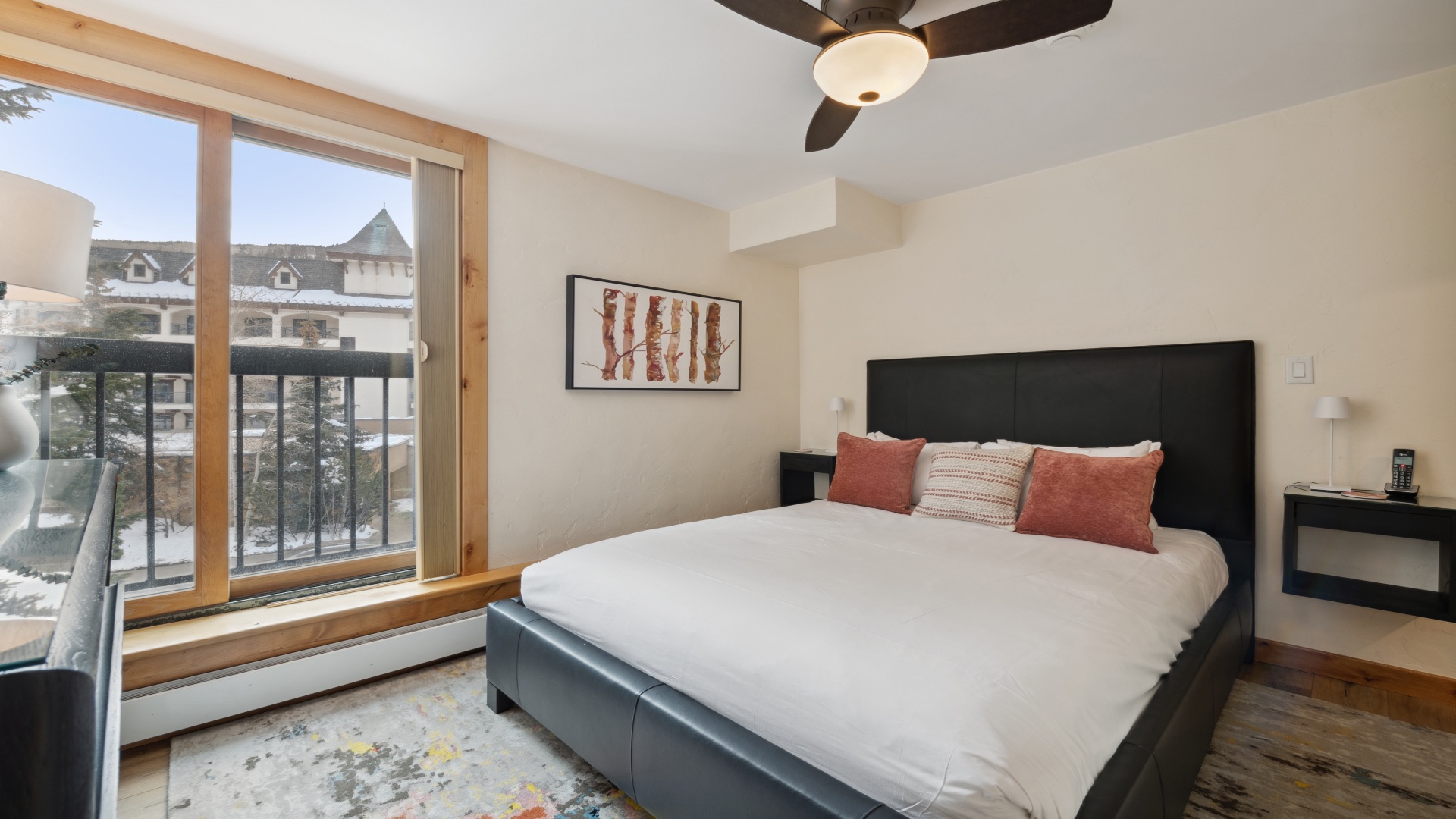 Sink into a plush bed and let mountain air refresh your mornings. Your private balcony overlooks a charming alpine village, while a ceiling fan keeps your space perfectly comfortable year-round.