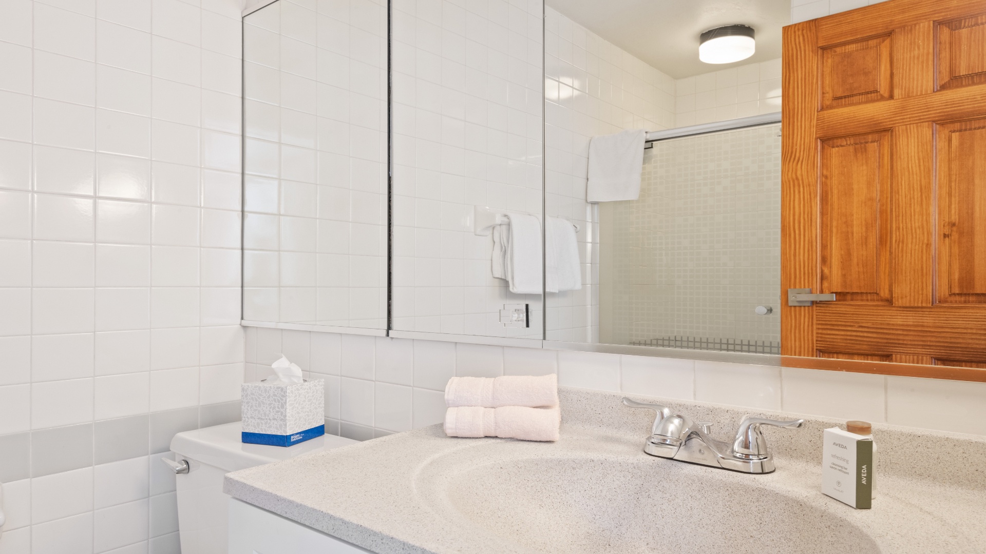 Step into a bright, spotless bathroom with fresh towels and complimentary toiletries waiting just for you—everything you need to unwind and feel right at home.