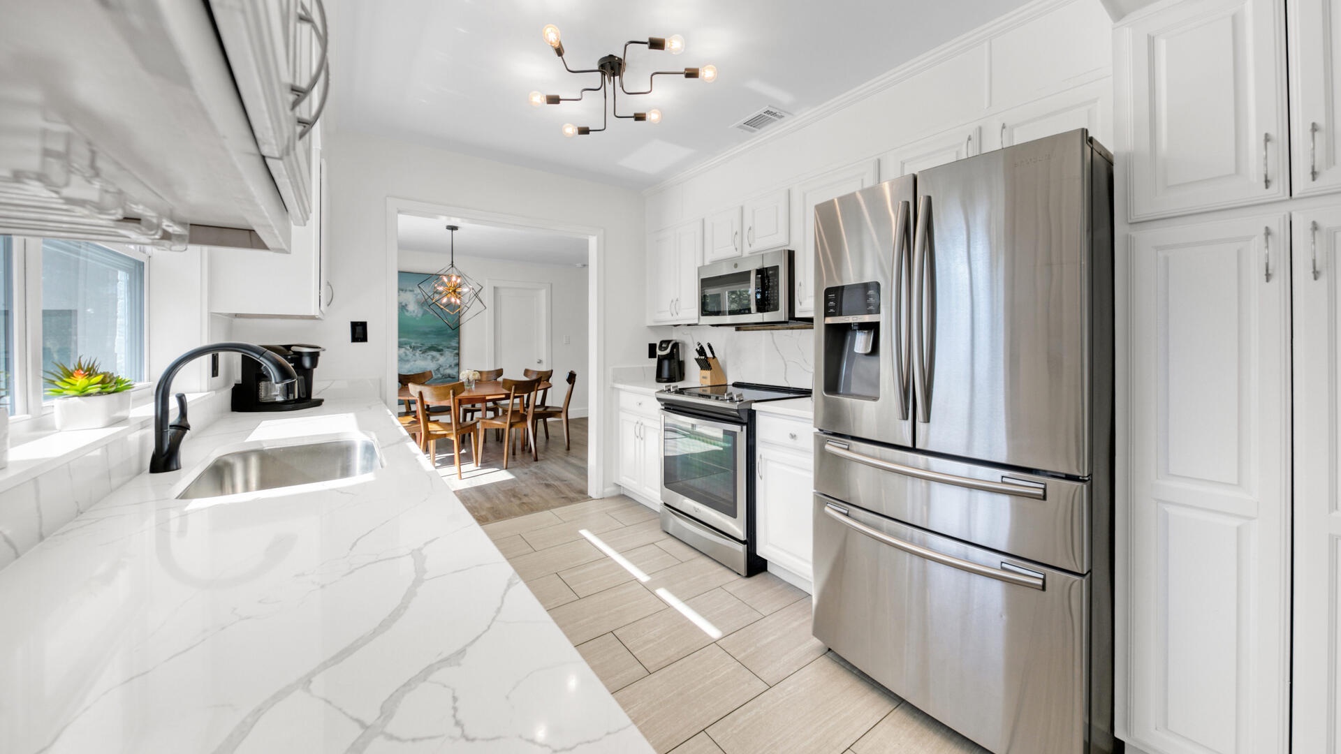 The fully stocked kitchen features quartz countertops and stainless appliances!