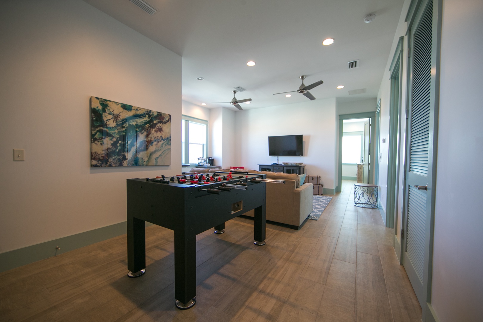 On the third floor, you'll find a family room with a flat screen TV, foosball table, and mini-fridge!