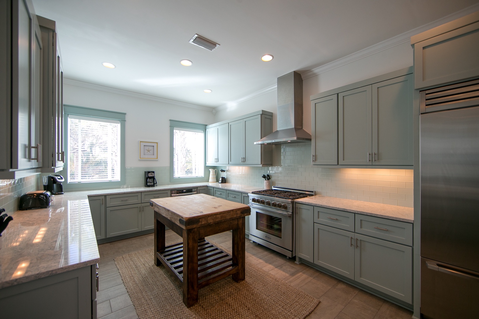 The gourmet kitchen offers high-end stainless steel appliances, a gas range, and endless counter space!
