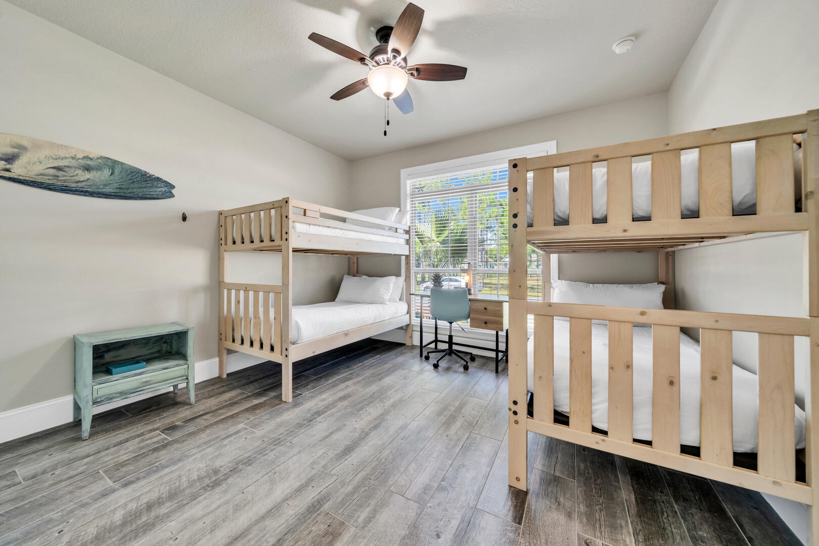 The bunk room features two twin bunks and a writing desk!