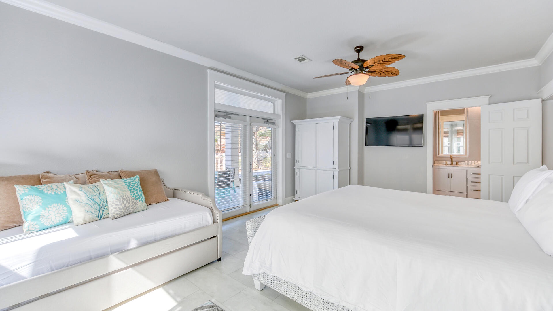 The ground floor master features a king size bed, with Jack-n-Jill bathroom and pool patio access!