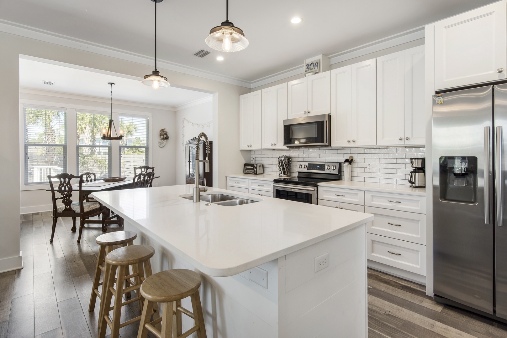 The well-stocked kitchen features light and bright finishes!