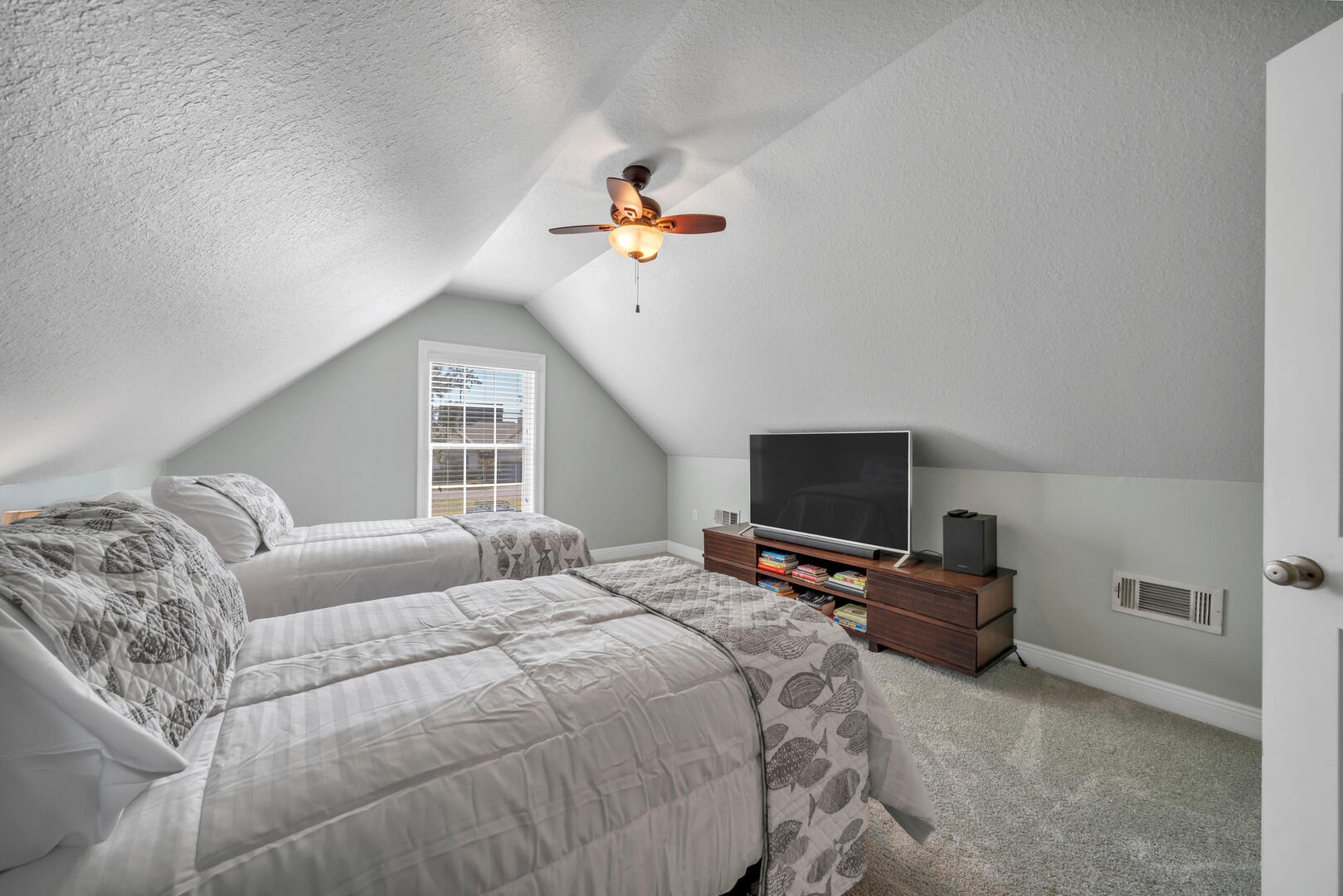 The loft bedroom features two twin beds and a flat screen TV!