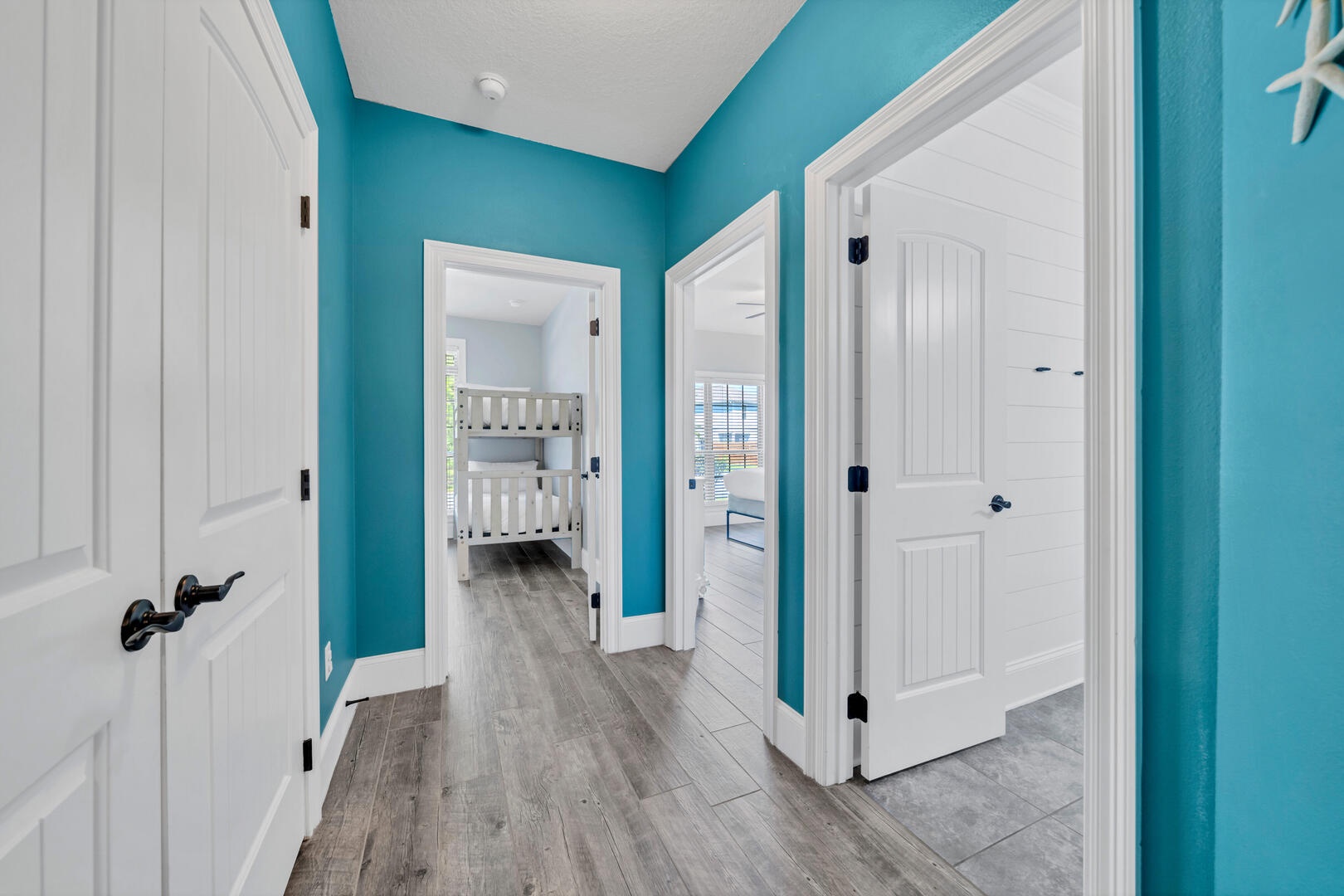 The hallways are beautifully outfitted with shiplap and pops of aqua color!
