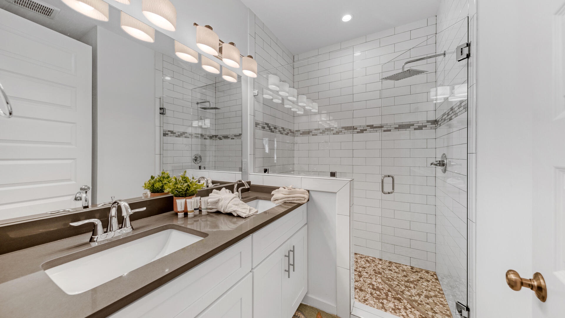 Guests on the ground floor share a large, full bathroom with walk-in shower and dual vanities!