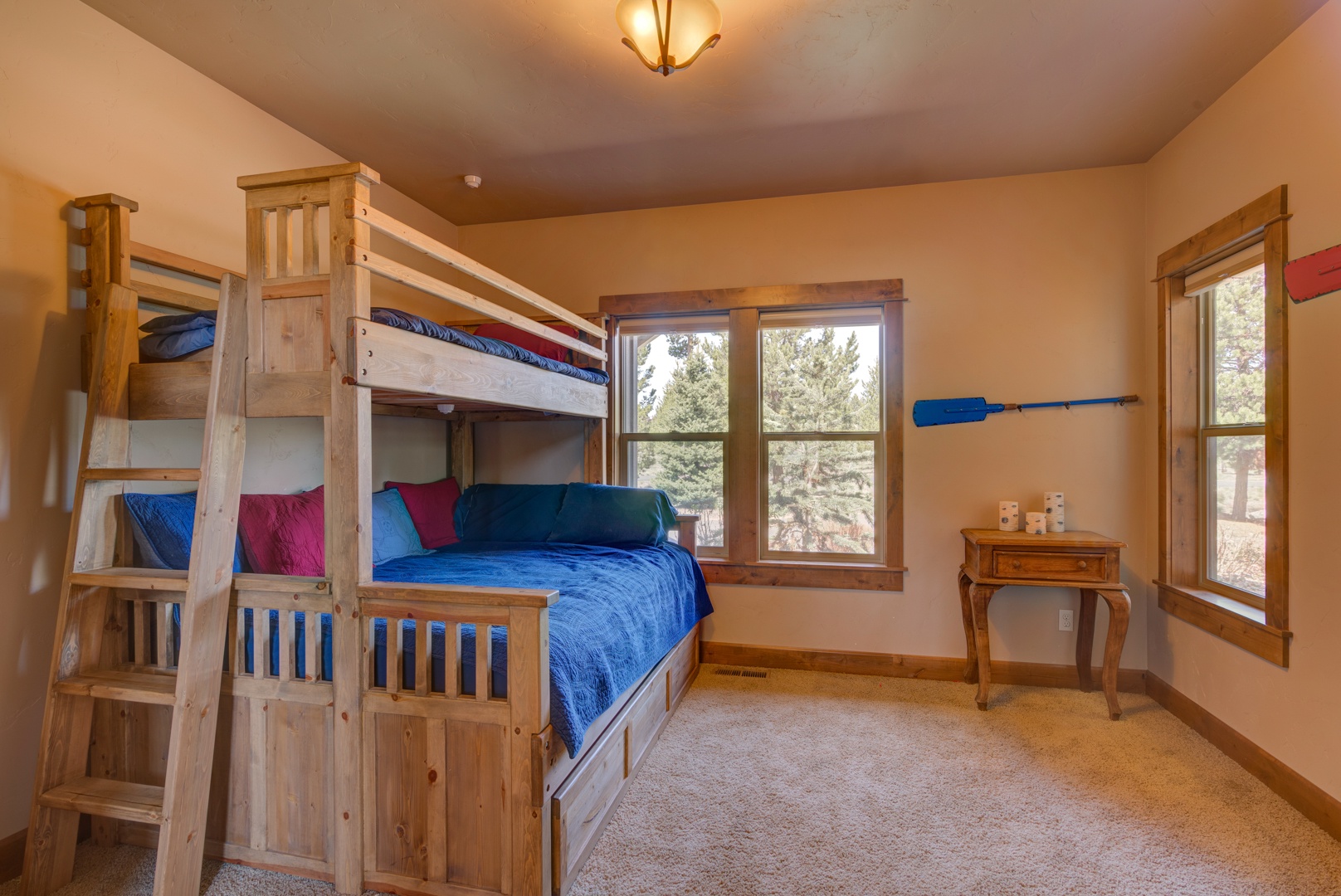 Guest bedroom with pyramid bunk beds and trundle.